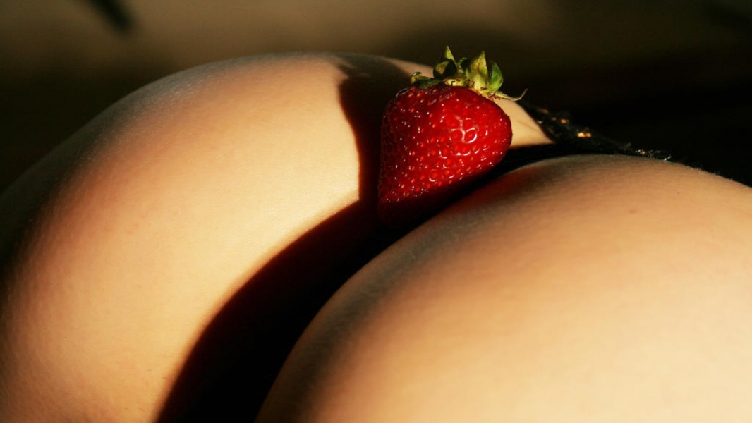 Erotic photo session with strawberries