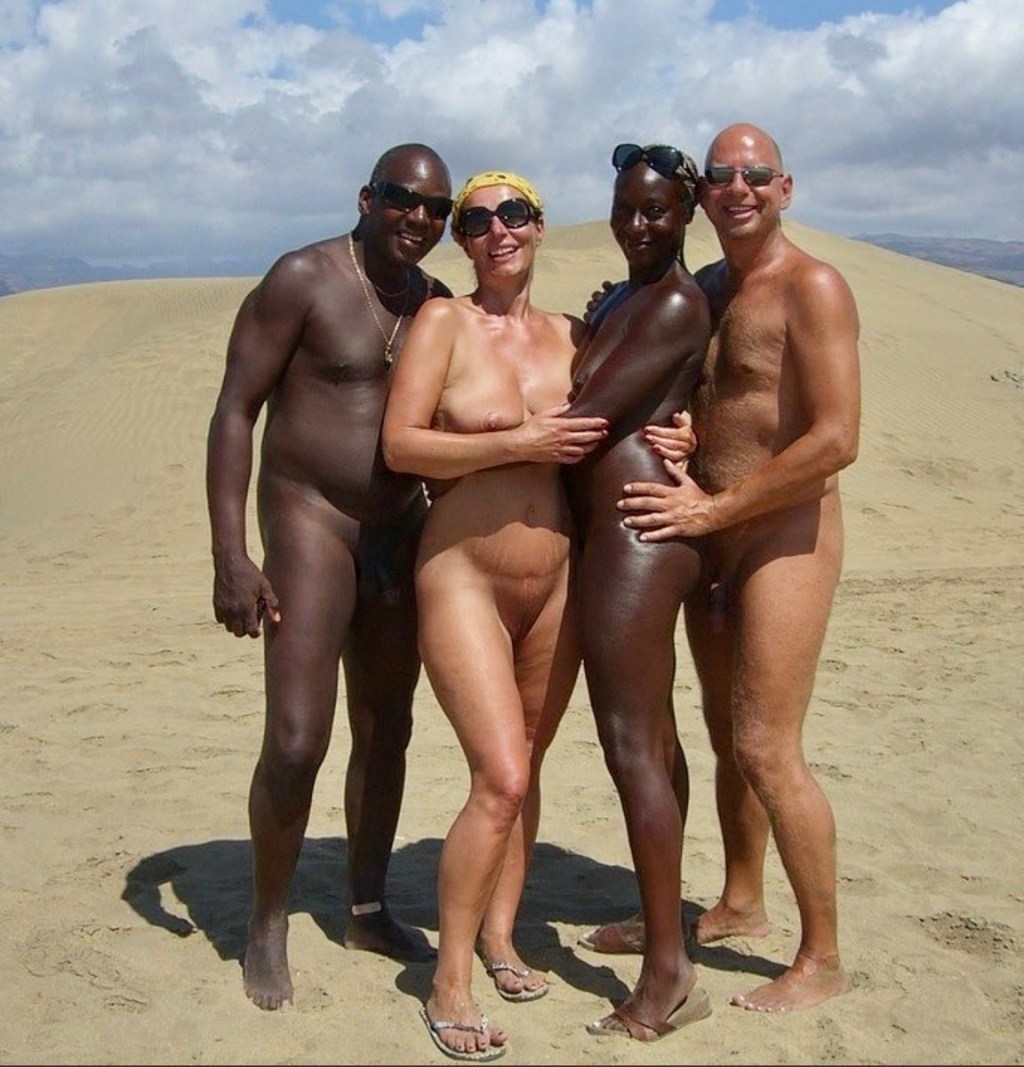 Nudists with blacks on the beach