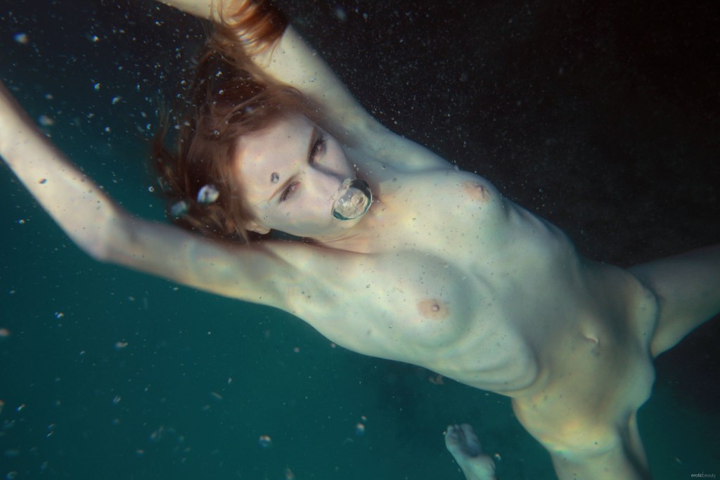 Submarine swimming of a woman nude