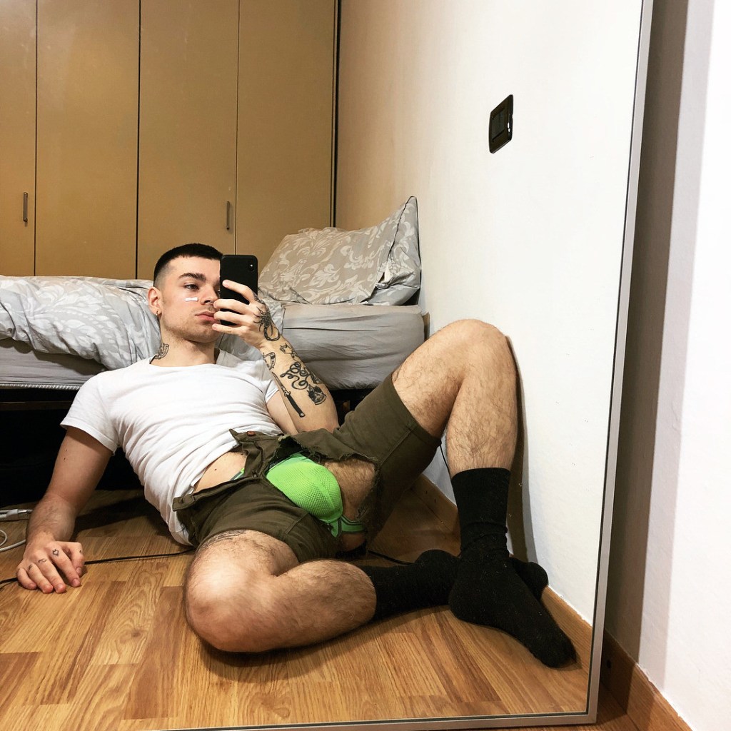 Men hug in bed