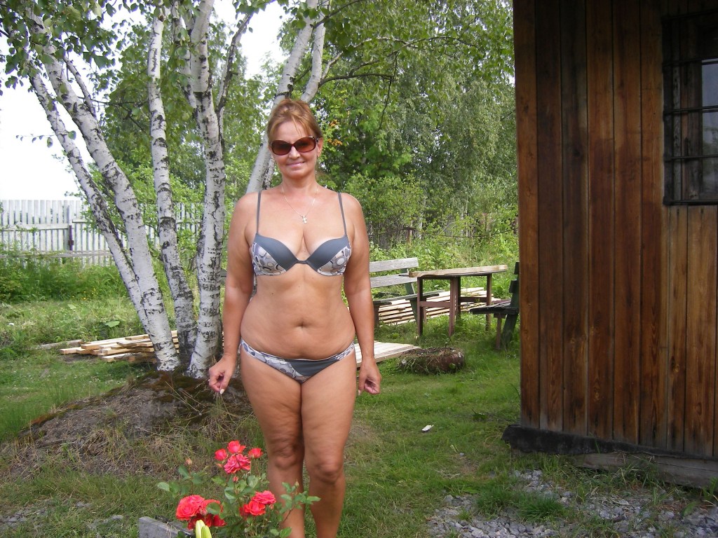Mature in a swimsuit in the country